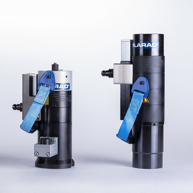 Two hydraulic torque wrenches with blue handles stand upright against a simple background, demonstrating precision similar to that of a multi-stage hydraulic tensioner from Plarad.